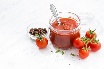 tomato sauce in a glass jar and white background