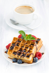 traditional sweet waffles and espresso on white table, vertical