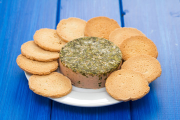 pate with toasts on white plate