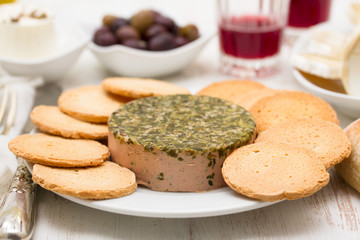 pate with herbs and toasts on white dish