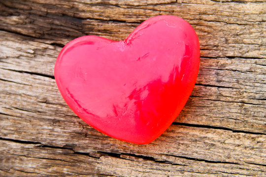 Heart shaped soap on wooden background