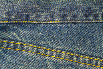 Blue jeans with seam, denim texture background, close up.