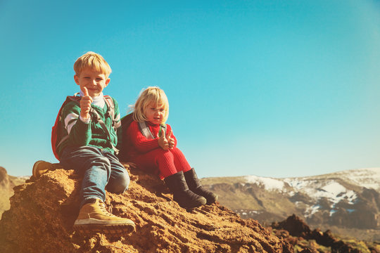 happy little boy and girl enjoy hiking in mountains