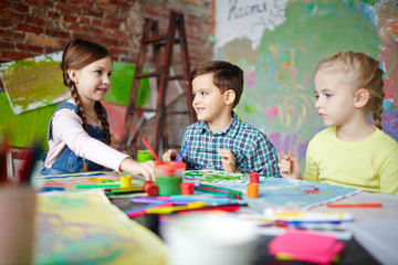 Fototapeta premium Creative children working in group at drawing lesson