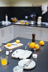 Eggs, oranges and other objects on kitchen table