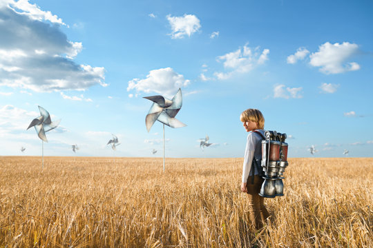Boy in a field with propellers