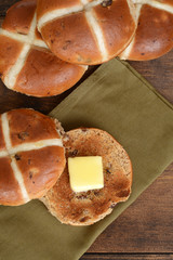 top view hot cross bun with butter on green napkin