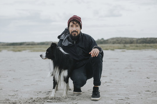 Man with Border Collie on beach