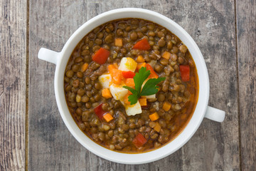 Lentil soup in a bowl on wooden background
