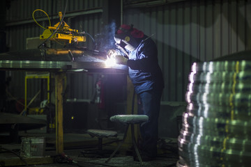 Man welding steel in factory