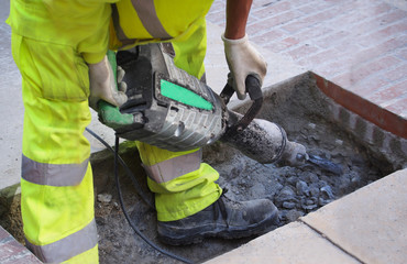 Fototapeta premium A man with a pavement saw
