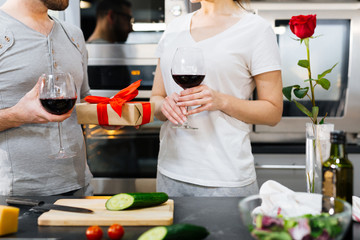 Amorous couple celebrating Valentine day at home in the kitchen