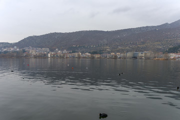Foggy winter scenery at the lake of Kastoria Greece, during a he - 136316733