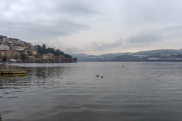 Foggy winter scenery at the lake of Kastoria Greece, during a he - 136316734