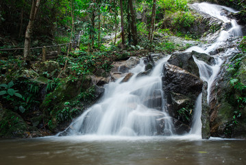 Naklejka na ściany i meble Waterfall in a lush rainforest. at Chiang Mai, Thailand.