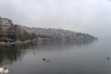 Foggy winter scenery at the lake of Kastoria Greece, during a he - 136318512
