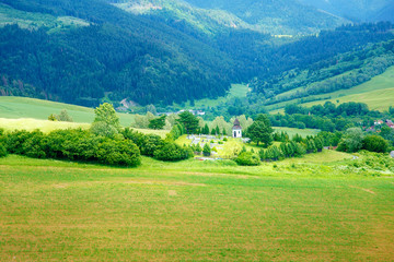 bell tower and cemetery and mountain landscape in slovakia.