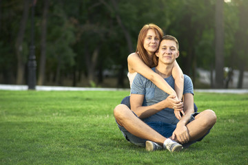 love couple sitting on the grass in the park