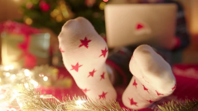 Close up of female feet in christmas socks dancing on Christmas eve