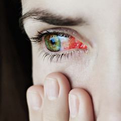 Fototapeta premium Closeup of irritated or infected red bloodshot eyes - conjunctivitis