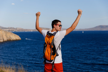 Guy with backpack near sea