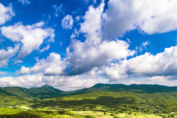 Mountain land and cloudy blue sky landscape