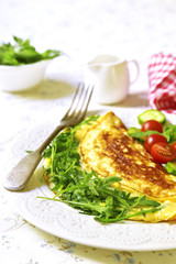Omelet with cheese and arugula - healthy diet breakfast on white
