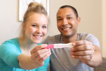 Couple happy with pregnancy test result 