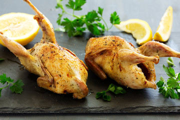 Delicious fried quail with herbs and greens.