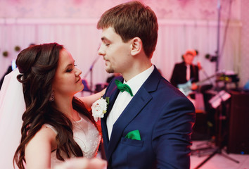 Happy newlyweds dancing the first dance