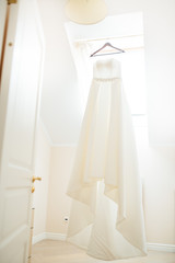 Wedding dress hanging in the middle of the room