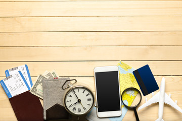 Travel objects on wooden background