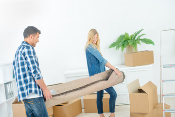 couple carrying a carpet