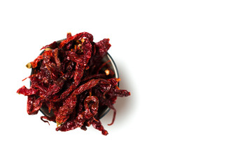 A dried chillies in a bowl isolated over white background