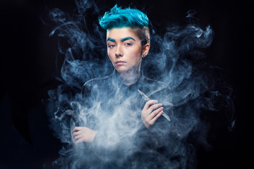 magic hipster woman with blue hair smoking vape on black background