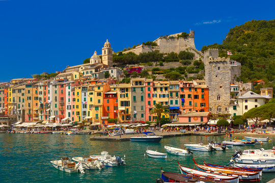 Colorful picturesque harbour of Porto Venere, San Lorenzo church and Doria Castle on the background, La Spezia, Liguria, Italy.