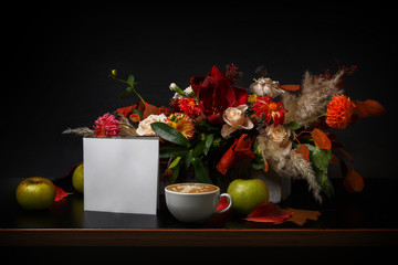 Cappuccino coffee and flowers composition on black background