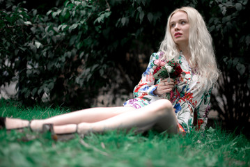 happy young blondie european woman on the grass