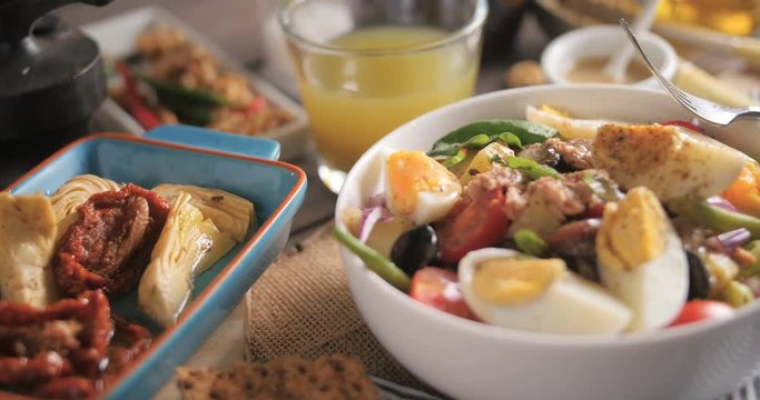 Dolly close up push in view of a fresh, healthy, organic nicoise salad