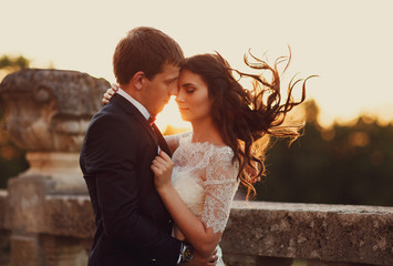 Romantic couple clung to each other at sunset