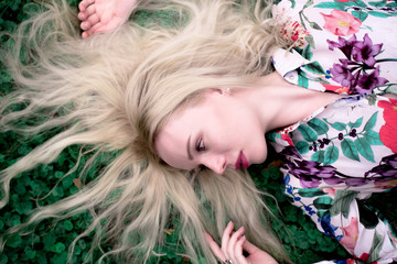 Naklejka premium happy young blondie european woman on the grass