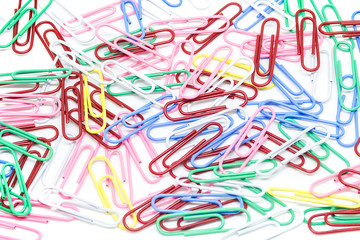 multi-colored paper clips on white background