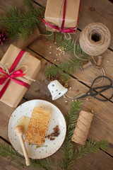 Packing gifts: honey comb, verdure and natural products.