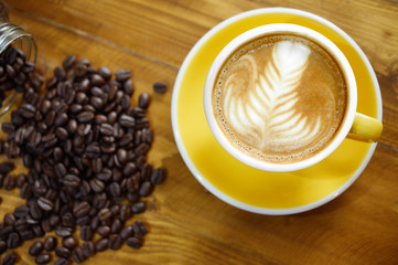 a cup of coffee latte art and mocha on old brown wooden backgrou