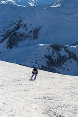 Skier standing in front of mountains