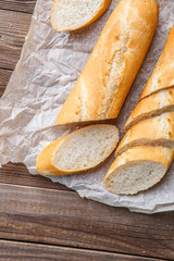 Wooden table with fresh baguette