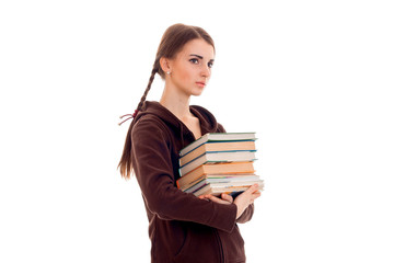 pretty young brunette student girl with a lot of books in hands isolated on white background