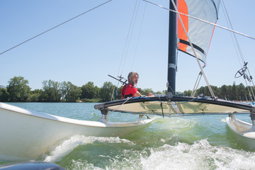 Naklejka premium enjoying extreme sailing with racing sailboat