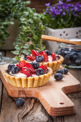 Fresh homemade fruit tart with strawberries and blueberries.