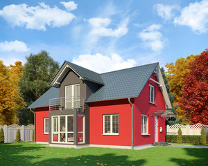 Fototapeta na wymiar Ein rot-schwarzes Einfamilienhaus in blühender Natur im Herbst